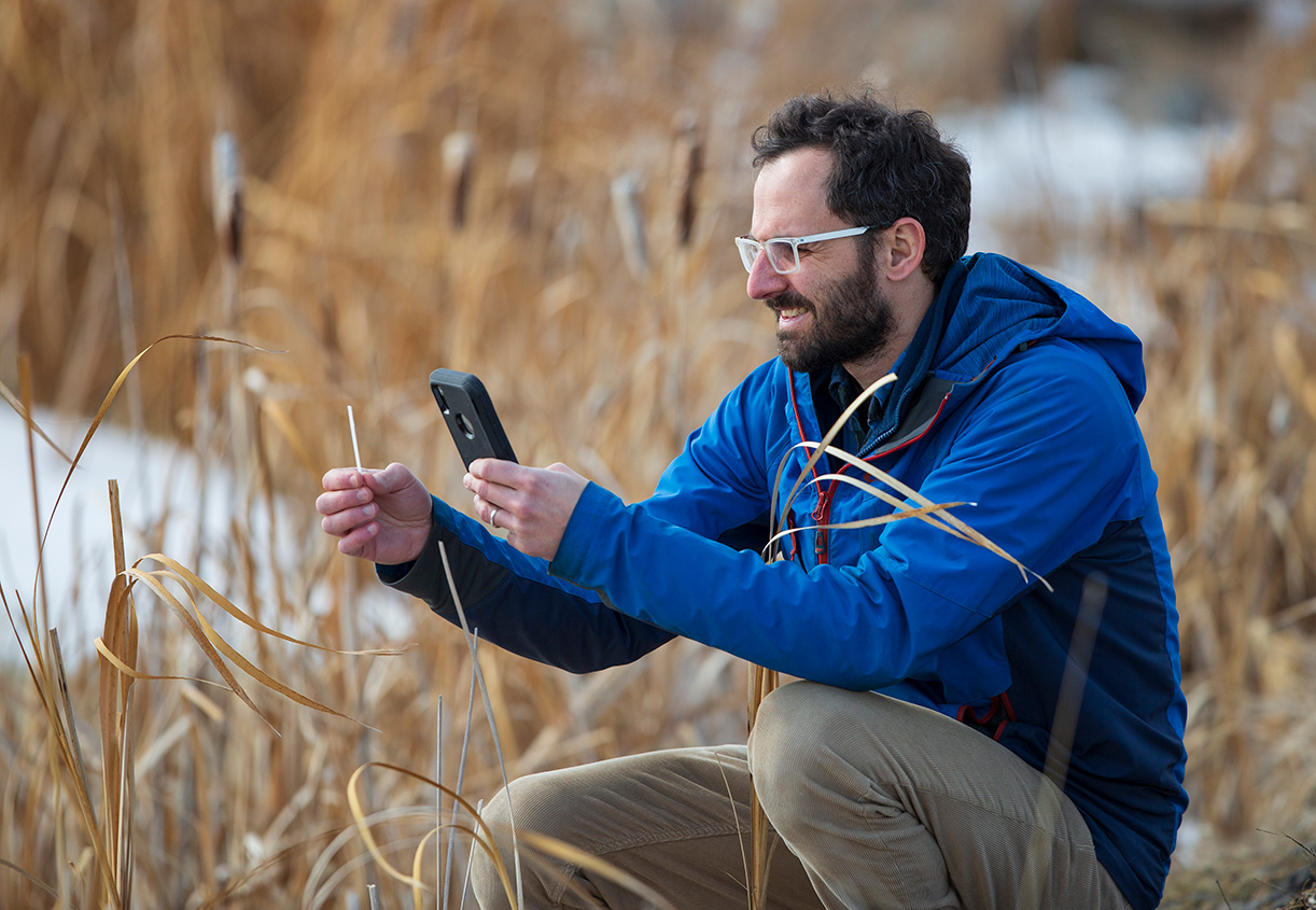 Diogo Costa uses the Nutrient app for testing water from a pond. (Credit: Dave Stobbe for the University of Saskatchewan)