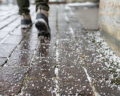 Excess de-icing salt on sidewalk (stock image).